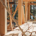 Sunlit construction site with wooden lumber arranged in rows. Perfect for building projects.