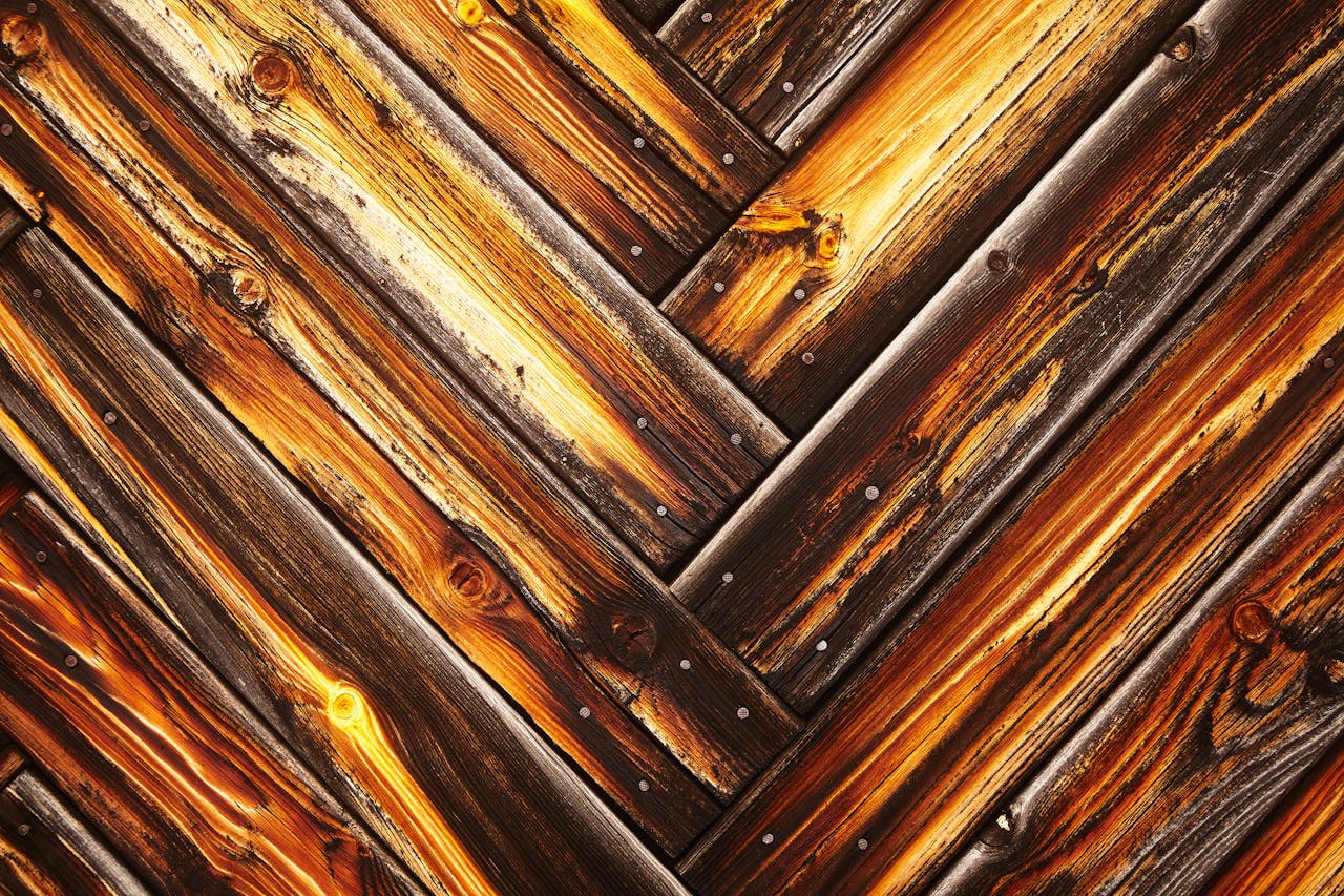 Close-up of a rustic, weathered wooden surface showcasing detailed grain and vibrant tones.